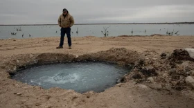 Hawk Dunlap stands at the site of Lake Boehmer, a brine lake that has leaked out of an old well in Pecos County. The Texas Commission on Environmental Quality received $10 million from lawmakers in 2023 to plug such wells but has yet to spend any of the money as it completes the rule making process.