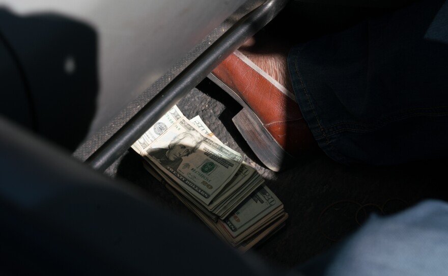 Alec Javial Karim, 45, ankle-deep in U.S. dollars. Karim was a banker until 2003, when he quit and started trading money on the black market instead.