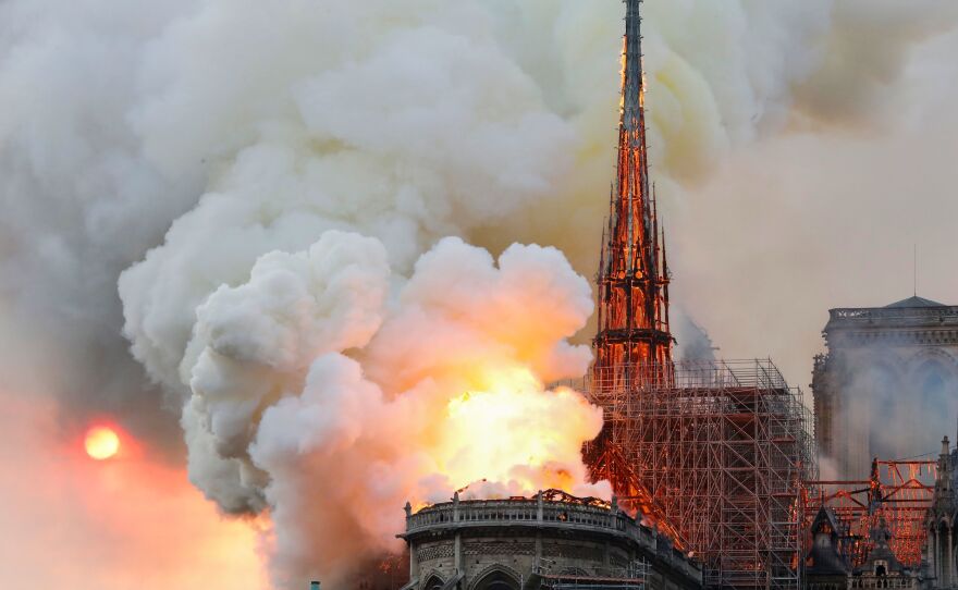 Smoke and flames rise from the famed cathedral.