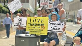 Protesters hold signs outside Richmond City Hall in August during a rally against Immigration and Customs Enforcement (ICE) detentions, calling for the city to bar local cooperation with federal immigration authorities.