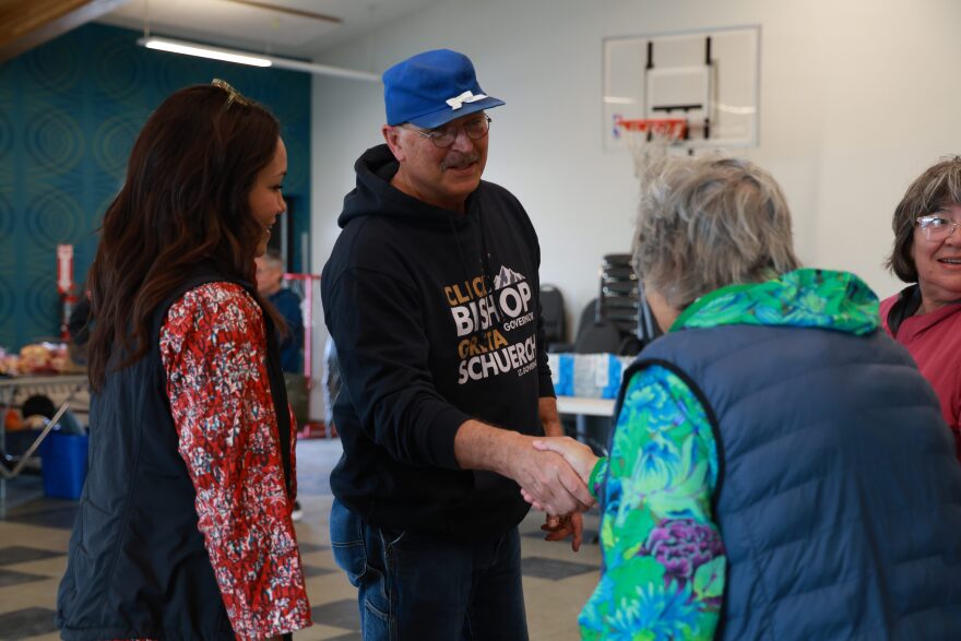 Click Bishop (center) shakes hands with Kotzebue residents at a meet-and-greet event on July 14.