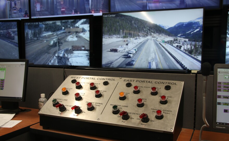 A silver control panel with several red buttons arranged in circles. One side says "West Portal Control" and the other side says "East Portal Control."
