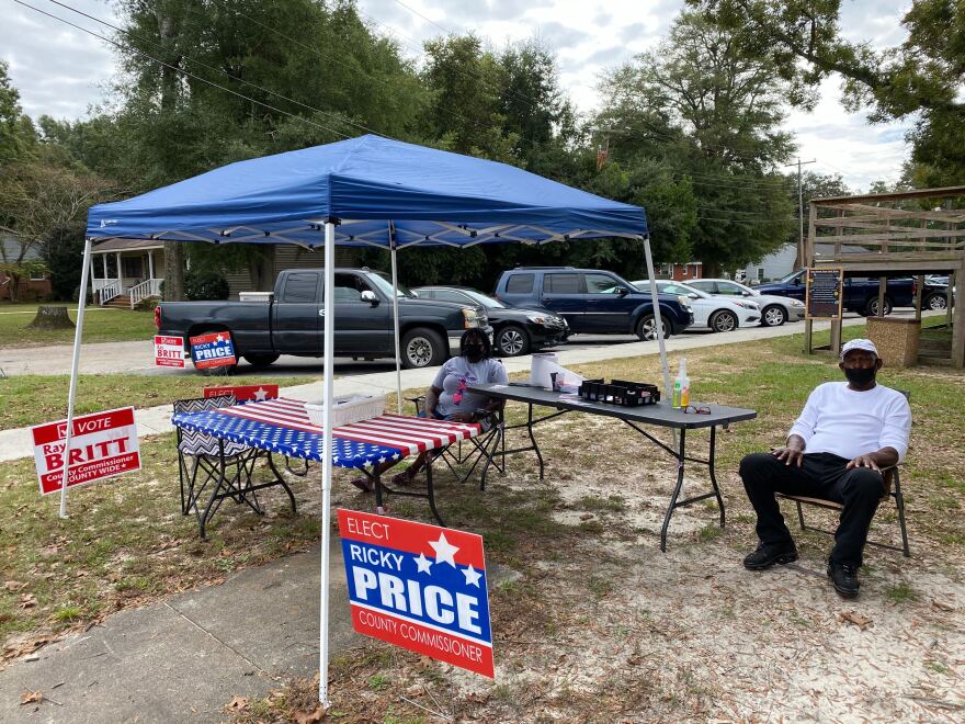 Cynthia and Levi Roberts sit at a booth for local candidates in Elizabethtown, Bladen County, on the first day of early voting.