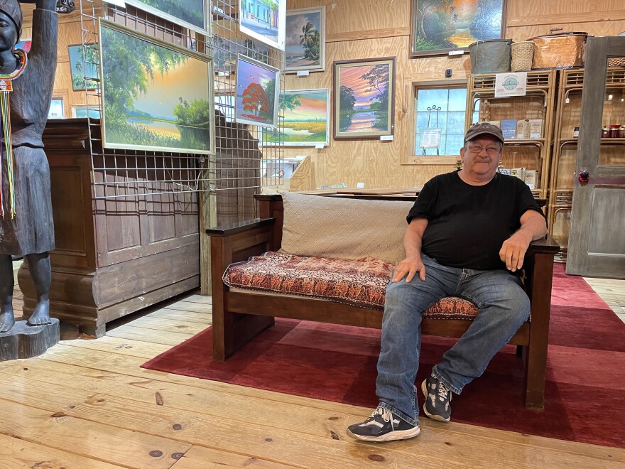 Doug Girard, who runs Micanopy Trading Outpost, spends his days helping customers and working with the shop owner to price antiques. (Sophia Bailly/WUFT News)