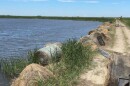 Hay bales holding back floodwater from overtaking a road in the rural Devils Lake Basin.