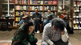 Participants in the Books & Books Reading Party read on a carpet and chairs as they indulge in the silence and communal solitude.