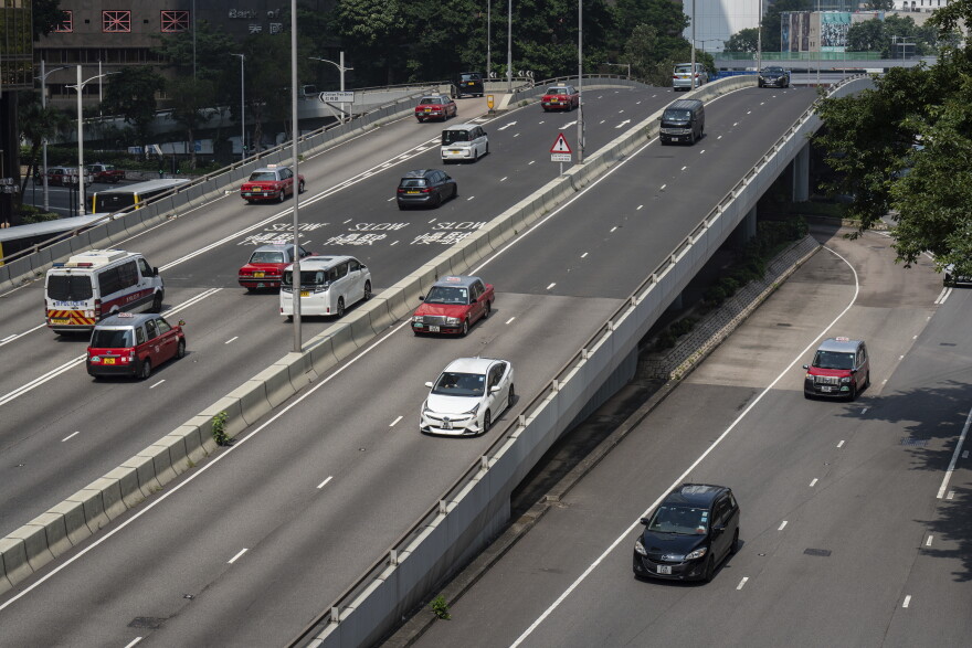 Cars move on an overbridge outside government headquarters in Hong Kong's Admiralty district, Saturday, Sept. 28, 2024. (AP Photo/Chan Long Hei)