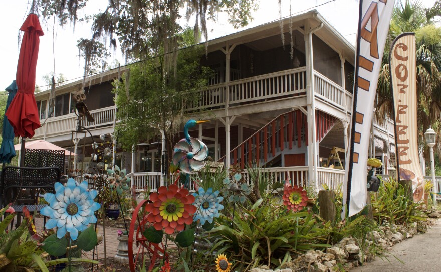 Metal lawn ornaments and colorful garden spinners sit outside a local storefront along Cholokka Boulevard, showcasing the eclectic charm of the historic town's downtown shopping district.