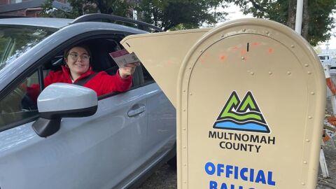 A voter drops off a ballot in a drop box in Portland, Ore., on Election Day, Tuesday, Nov. 8, 2022.
