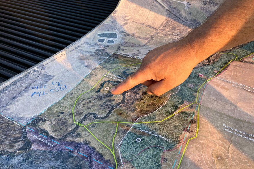 Jathan Chicoine points to an oxbow scar next to Bear Creek on his farm near Story City, Iowa.