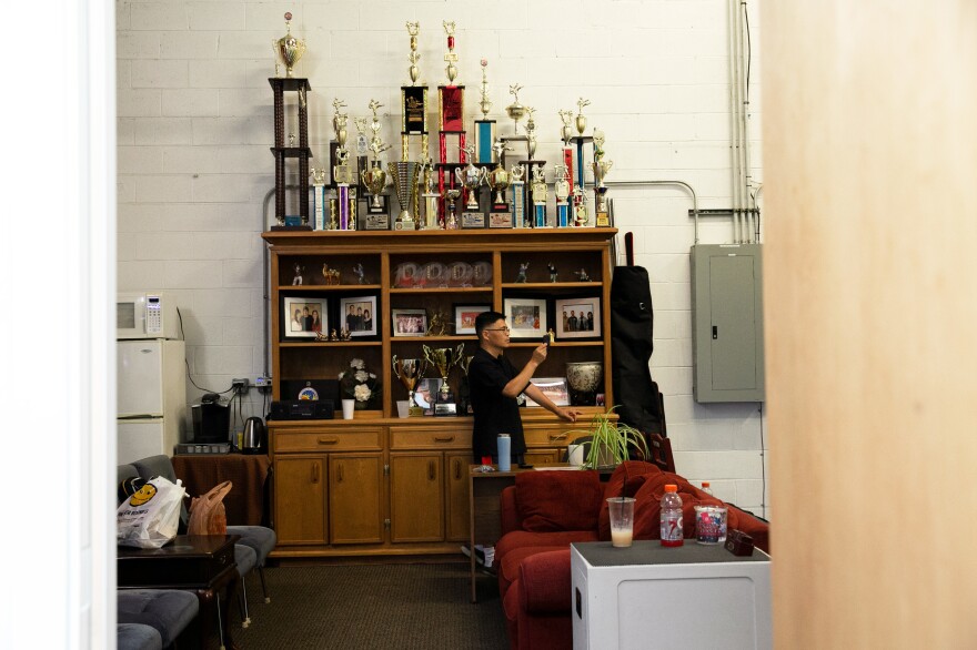 Henry Wong records his 10-year-old son Tony Wong practicing. Pei and Zhang's overarching goal for the academy is to help students become a better person.