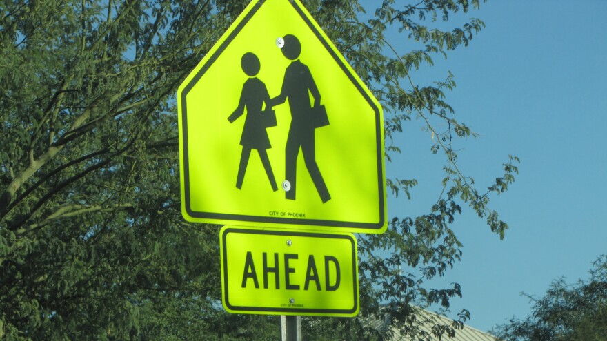 a yellow sign indicating a crossing ahead