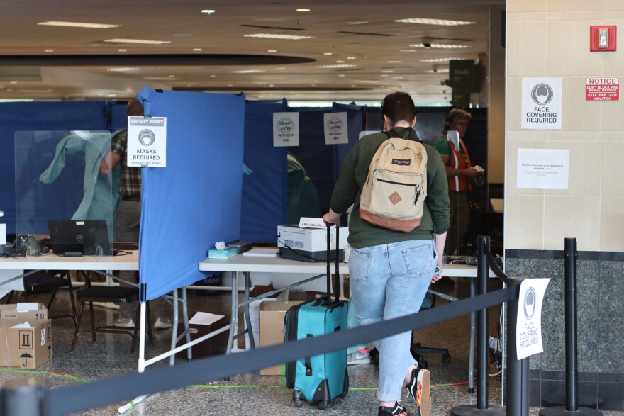A traveler who recently arrived on a flight from out of state prepares to get tested for COVID-19 at the Ted Stevens Anchorage International Airport on Monday, June 22, 2020. (Tegan Hanlon/Alaska Public Media)