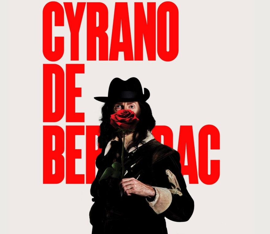 The words "CYRANO DE BERGERAC" in red, behind a man in black with a red rose in front of his face.