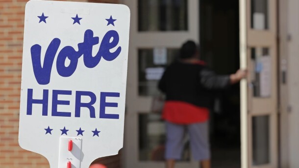 A voter enters an indoor polling place.