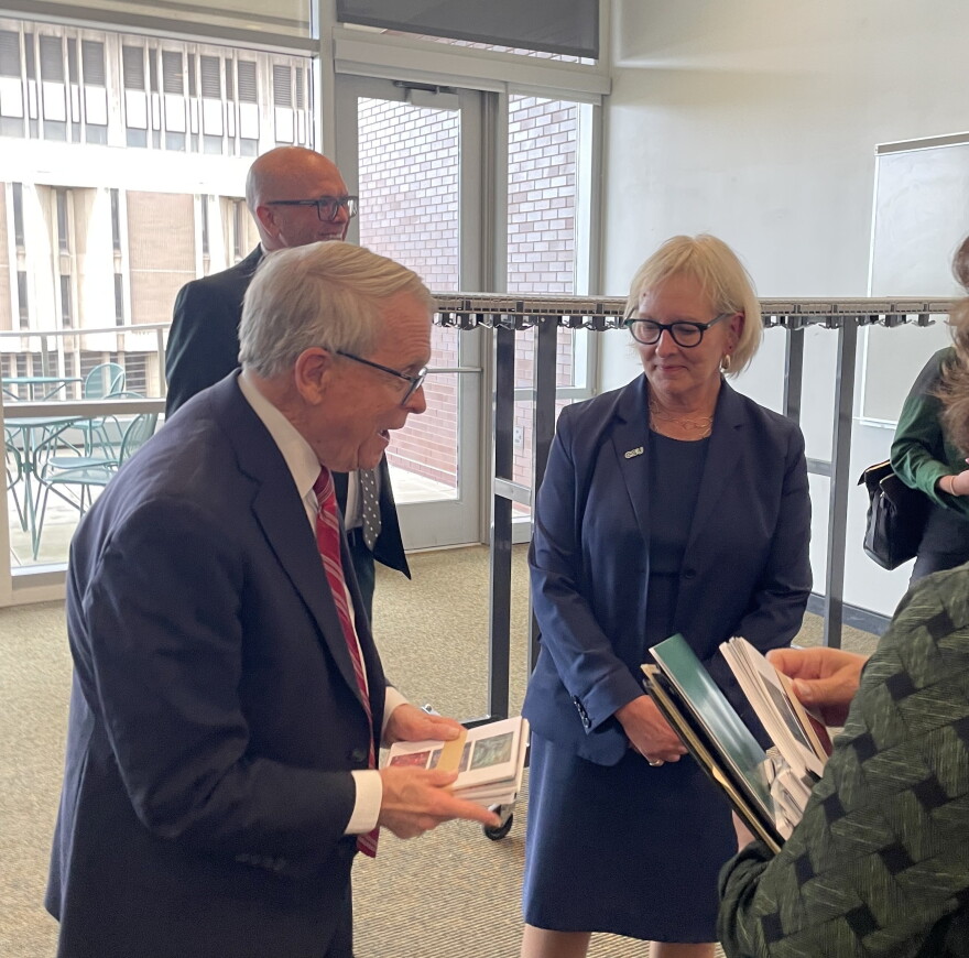 Ohio Governor Mike DeWine, left, receives notecards designed by students from Cleveland State University President Laura Bloomberg after her State of the University speech on October 14, 2026.