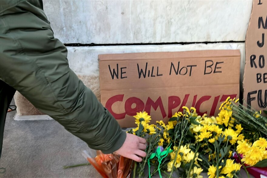 Dozens of rally attendees place flowers on the steps of the New Haven Superior Court, to honor the life of Renee Nicole Good who was fatally shot by an Immigration Customs Enforcement agent Wednesday, and all other people who have died or disappeared while in ICE custody.
