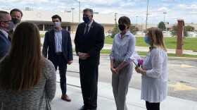 Group standing outside wearing masks