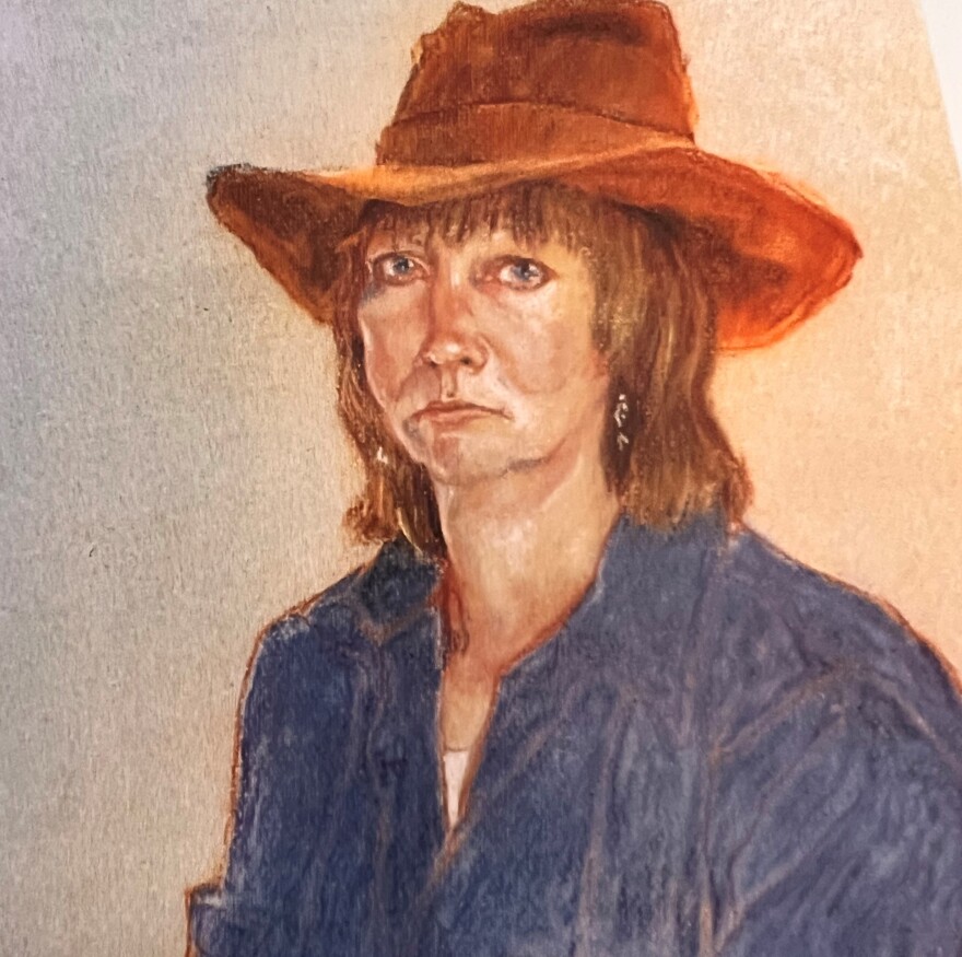A self portrait drawing of a 40-year old white woman wearing a blue shirt and brown hat.