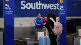 A Southwest Airlines traveler checks a bag at Midway International Airport, Tuesday, March 11, 2025, in Chicago.