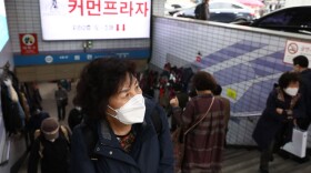 People walk along the Namdaemun market on March 17, 2022 in Seoul, South Korea.  (Chung Sung-Jun/Getty Images)