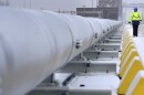 FILE — A worker walks past a gas tube that connects the 'Hoegh Esperanza' Floating Storage and Regasification Unit with main land during the opening of the LNG (liquefied natural gas) terminal in Wilhelmshaven, Germany, Dec. 17, 2022.