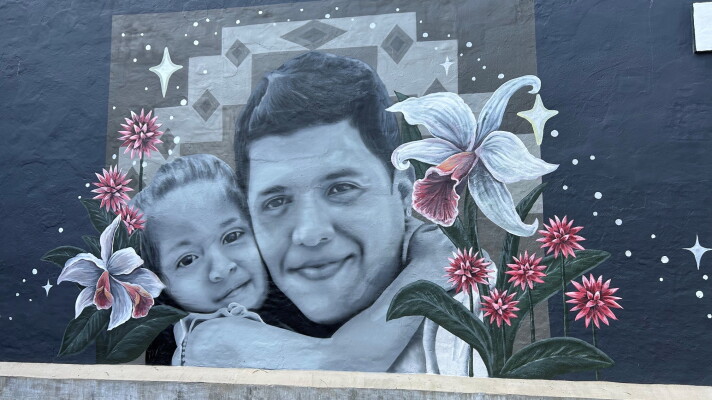 A mural of Johan Sebastian Guererro and his daughter on a building in Biddeford.