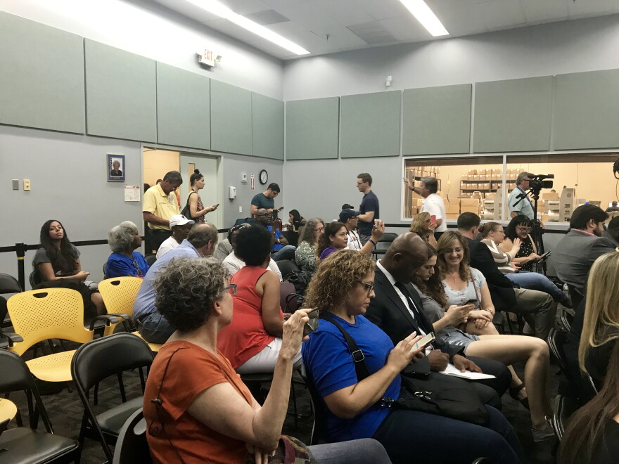A couple dozen people watch the Broward canvassing board review the last 25 pages of ballots for voter intent Saturday afternoon. 