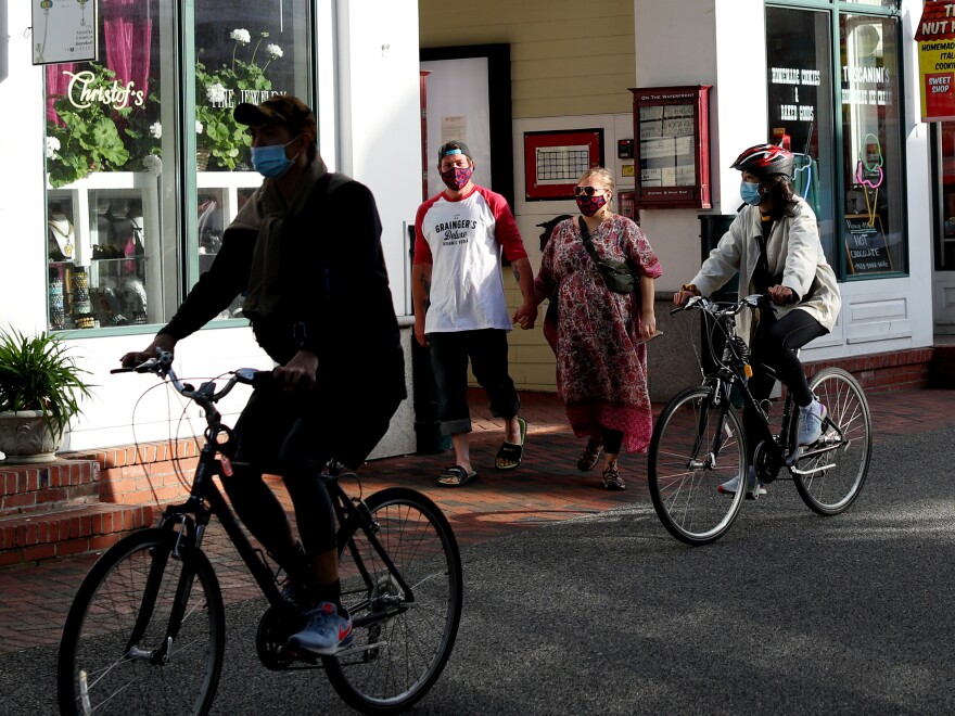 Pedestrians walk down Commercial Street in Provincetown, Mass., last May. A study of a new outbreak in Provincetown found that three-quarters of those infected were fully vaccinated.