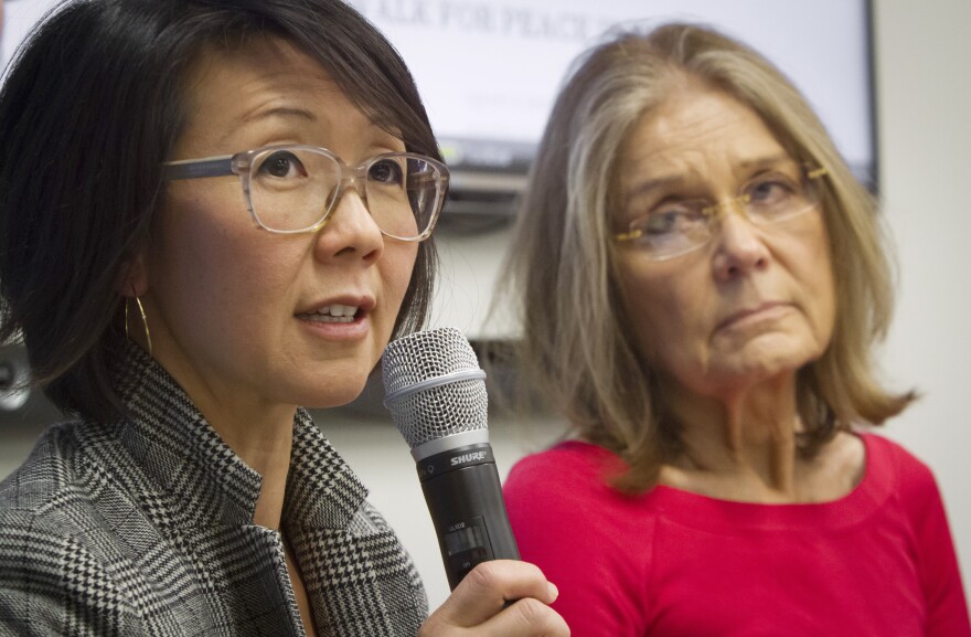 FILE - Organizers of the effort called WomenCrossDMZ.org, including lead coordinator Christine Ahn, left, and honorary co-chair Gloria Steinem, right, hold a United Nations news conference announcing plans for a rare and risky women's walk across the demilitarized zone between North and South Korea to call for reunification, in this March 11, 2015 file photo.