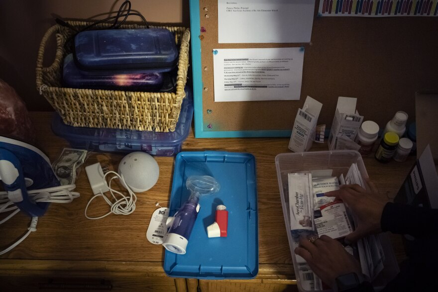 Catherine Manson sorts through asthma medication for her children in Hartford, Conn., on Wednesday, May 25, 2022. A 2019 analysis highlighted by the Asthma and Allergy Foundation found that exposure to pollutants - specifically, fine particulate matter - was disproportionately experienced by Black and Hispanic populations, while the emissions were disproportionately caused by white populations.