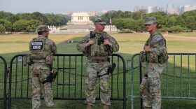 Member of the National Guard patrol at the base of the Washington Monument, Wednesday, July 15, 2026, in Washington. The Lincoln Memorial is in the background.