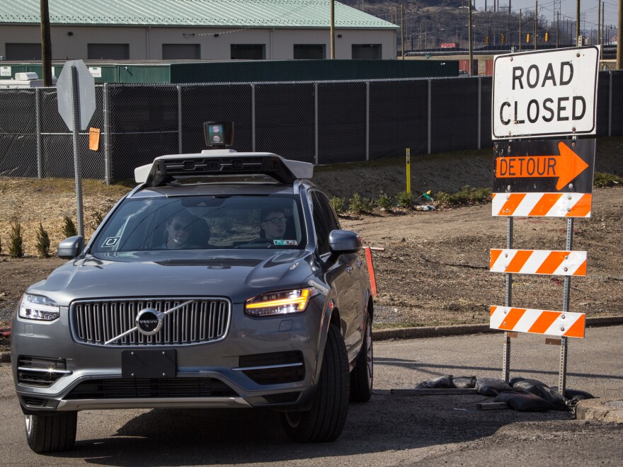 In Pittsburgh, where Uber is testing self-driving cars, each autonomous vehicle has two employees in the front seat; one is ready to grab the wheel and apply a foot to the brake pedal, the other in the passenger seat, has a computer screen showing what the car's rooftop laser-bouncing radar is seeing.