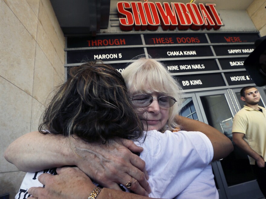 Longtime employees hug as they leave the Showboat Casino Hotel on Aug. 31, the day it closed.