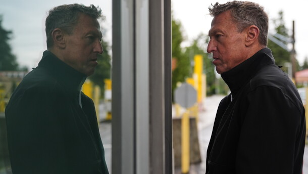 Commissioner of U.S. Customs and Border Protection Rodney Scott is reflected in a window as he speaks with an officer in a border crossing booth during a visit at the Point Roberts port of entry between the United States and Canada, Thursday, Oct. 22, 2026, in Point Roberts, Wash.