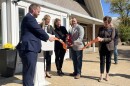 Krown LLC co-founders Allison Dries (middle left) and Eric Labraaten (middle right) cut the ribbon outside of their new cannabis infusion facility on Tuesday.