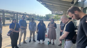 Members of We Make Indiana say a prayer at the Transpo transfer station downtown South Bend on Thursday, as part of their press conference urging Microsoft to pay into a community fund as they build their Granger data center.