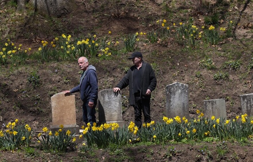 Bill Whitney, left, and Mykel Whitney survey their handiwork in "The Kettle" of Mount Hope Cemetery.