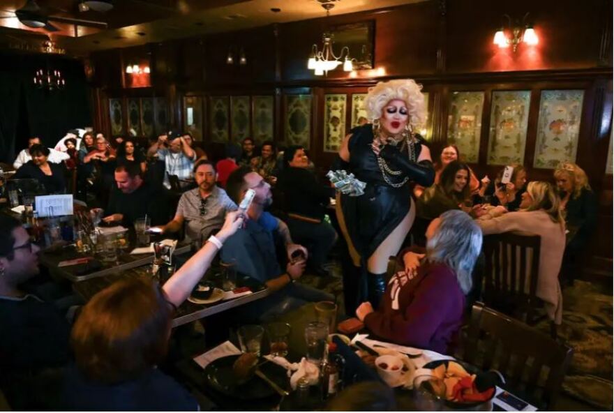  Daphne Rio, host of BuZz n’ BabeZz Drag Brunch, collects tips at the end the Jan. 14 show. 