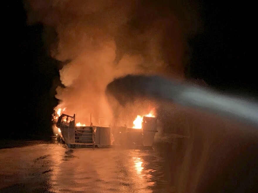 FILE - In this Sept. 2, 2019, file photo, provided by the Ventura County Fire Department, VCFD firefighters respond to a fire aboard the Conception dive boat fire in the Santa Barbara Channel off the coast of Southern California. The Coast Guard has announced several new safety rules following the deadly blaze that sent dozens of people on a scuba diving boat to a watery grave off the California coast more than two years ago. (Ventura County Fire Department via AP, File)