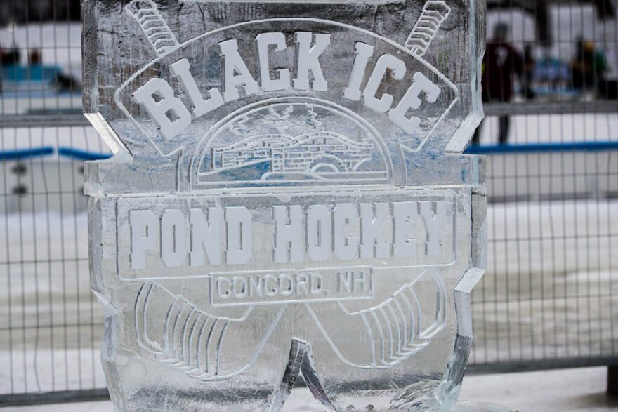 An ice sculpture of the Black Ice Pond Hockey logo