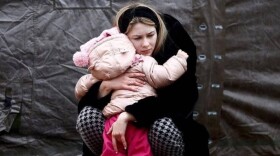 A Ukrainian woman hugs a child in a photo taken by a member of Dattalion.