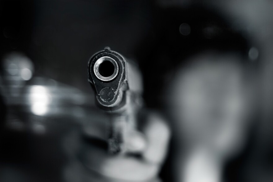closeup of the barrel of a handgun with the background blurred