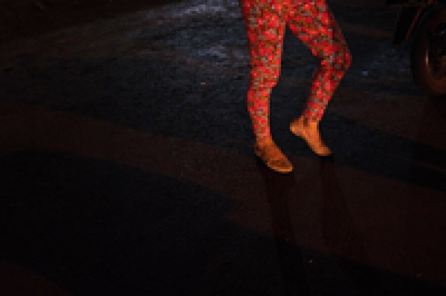 Mika Askiyah, 39, is busking on the street. To earn a living, waria in Indonesia often do sex work or sing on the street for tips.