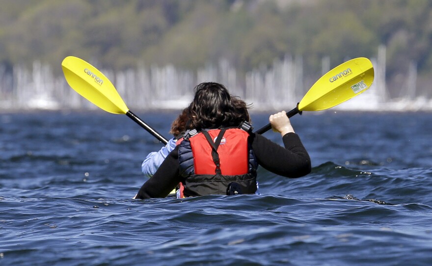  A kayak appears to momentarily disappear as large waves rise around it and a pair of paddlers taking an outing in Elliott Bay on an unusually sunny day Friday, April 21, 2017, in Seattle.