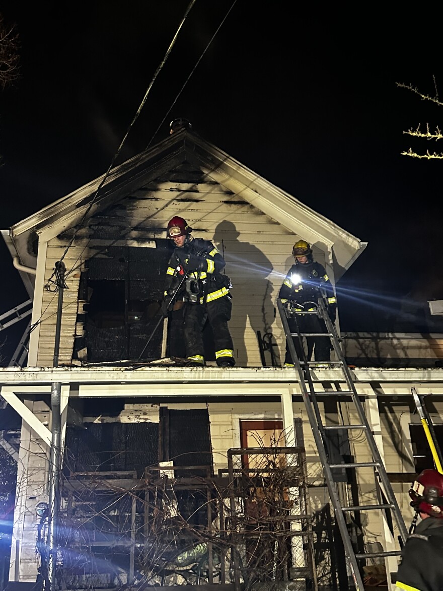 A firefighter on a roof