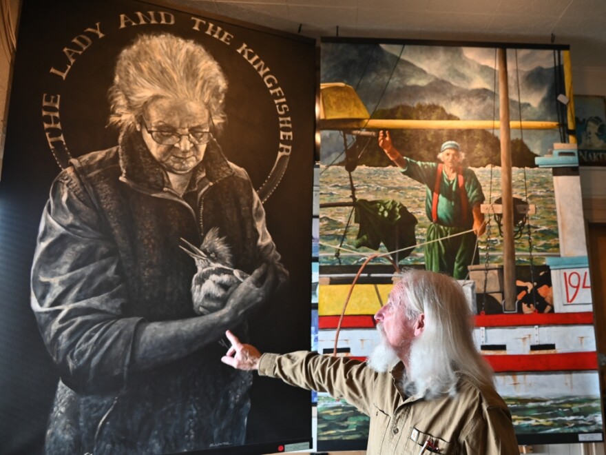 Lawrie points to his portrait of bartender Rita Ledbetter.