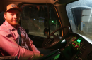 Man Sitting in driver's seat of semi-truck