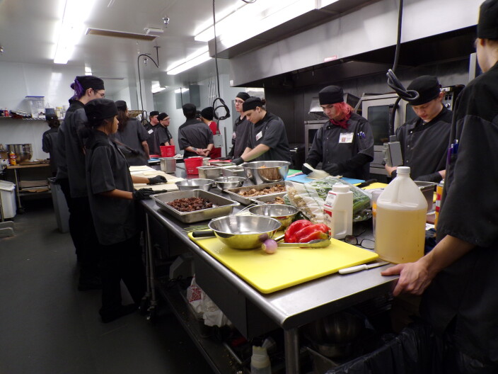 Young adults cooking in Life's Kitchen.