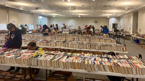 Customers peruse the many tables covered in neatly-lined used books for the Athens-Clarke County Library Fall Book Sale.
